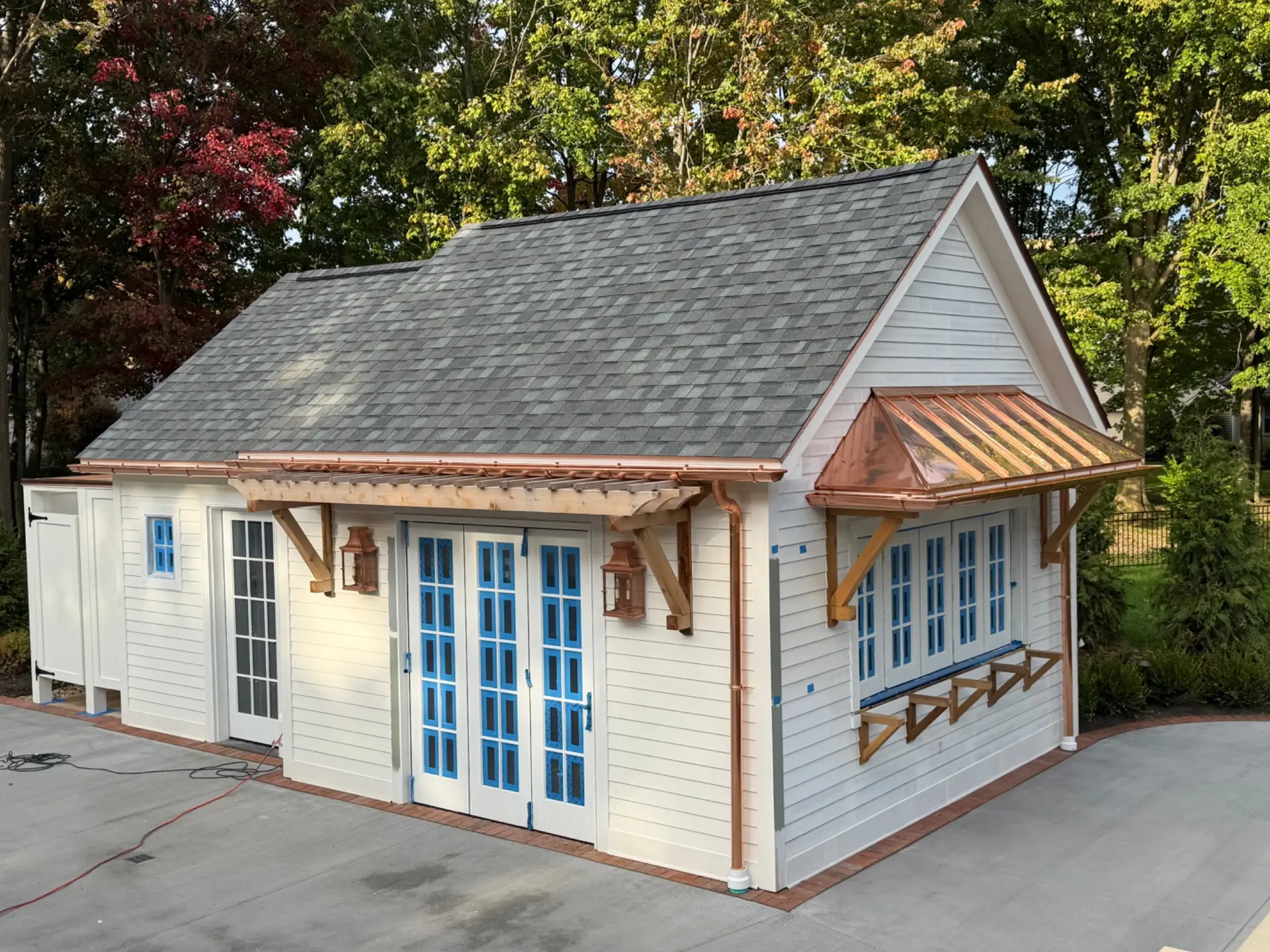 Copper standing-seam canopy and copper gutters on a pool house